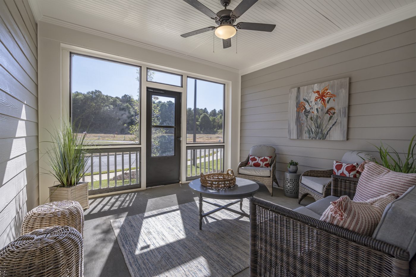 Decorated screened-in porch in a new construction home by Paran Homes