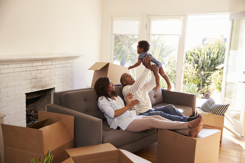 First-Time Homeowners Take A Break On Sofa With Son On Moving Day ©Monkey Business Images