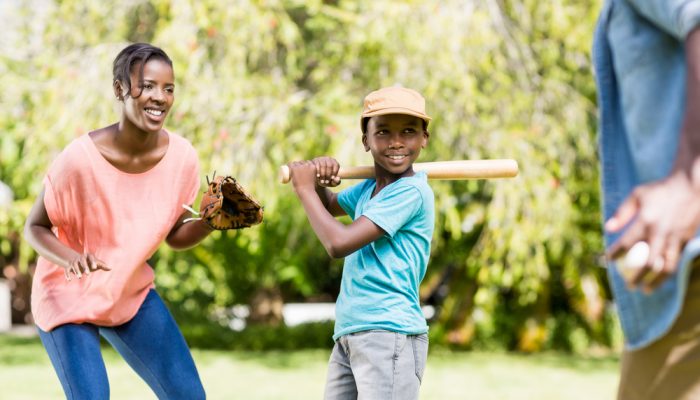 Happy family playing baseball at the park ©wavebreakmedia