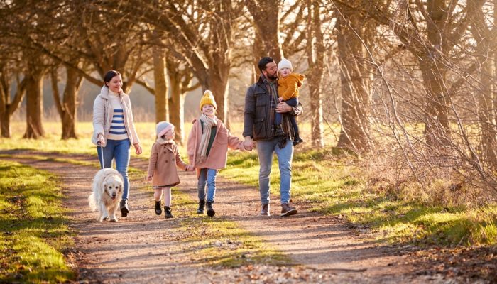 Family Walking in Park for Winter Break Getaway ©Monkey Business Images